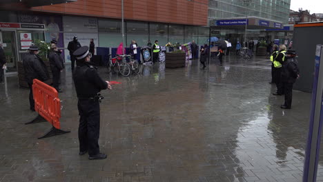 Police-officers-and-union-members-representing-workers-observe-a-minute-silence-for-healthcare-staff-who-died-due-to-the-Coronavirus-outbreak-on-Workers-Memorial-Day-outside-The-Royal-London-Hospital