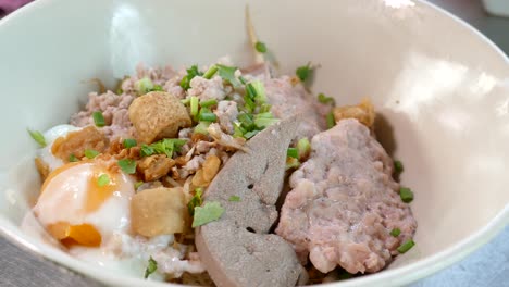 Close-up-Footage-of-Thai-Styled-Egg-Noodles-With-Minced-Pork-Cake-and-Pork-Liver,-Thailand-Popular-Street-Food