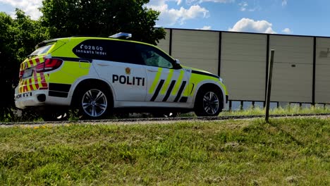 Norwegian-police-car-standing-and-blocking-the-road-to-the-accident-on-a-signal