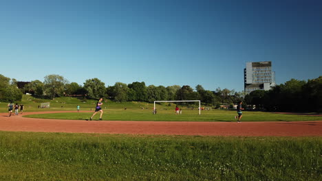 Wide-shot-of-track-and-field-joggers-on-a-sunny-day