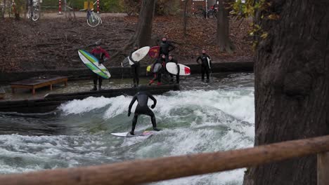 Slow-motion-of-surfers-that-having-fun-at-Eisbach,-Munich