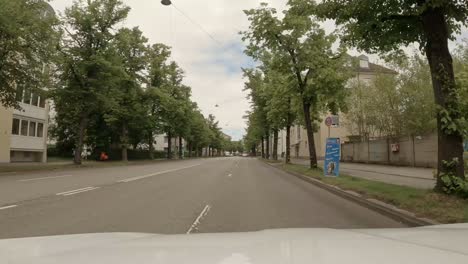 Driving-by-car-through-the-bavarian-capital-Munich-straight-along-the-street-called-"Mittlerer-Ring",-other-cars-passing-by