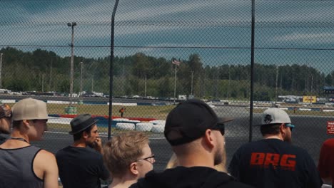 Large-Group-of-Fans-Behind-a-Fencing-Watching-Drifting-Event