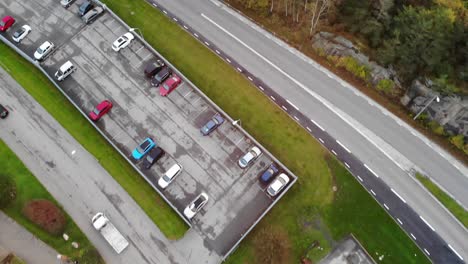 Top-down-aerial-view-of-parking-lot-in-Sweden-suburb-area,-Gothenburg
