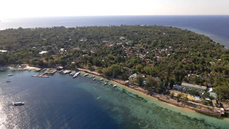 Aerial-wide-shot-of-Gili-Air-Island-with,trees,ocean,boats,beach-during-beautiful-weather
