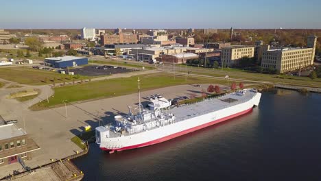 Rotating-aerial-shot-of-WWII-ship-USS-LST-393-in-Muskegon,-Michigan