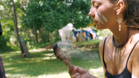 Woman-with-Face-Paint-Burning-Sage-Incense-for-Smoke-at-Celebrate-Life-Gathering