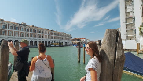 Beautiful-dolly-shot-of-tourists-taking-pictures-of-beautiful-canals-in-Venice-during-sunny-day-at-holiday