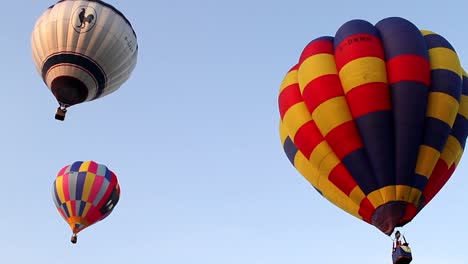 Three-hot-air-balloons-flying-high-to-the-blue-sky-at-Bristol-balloon-fiesta