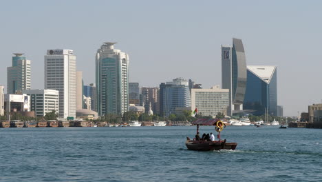 Unrecognizable-boatman-sailing-lonely-on-Dubai-Creek.-Static