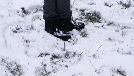 Slow-motion-shot-of-person-shooting-snowball-with-boots-on-white-winter-landscape