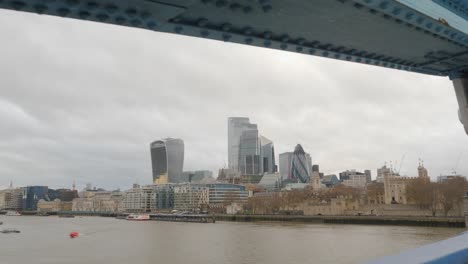 Walking-on-Tower-Bridge,-looking-left-over-the-river-to-Gherkin-building