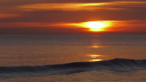 Hazy-sunrise-sky-over-calm-sea-at-dawn,-mediterranean,-spain