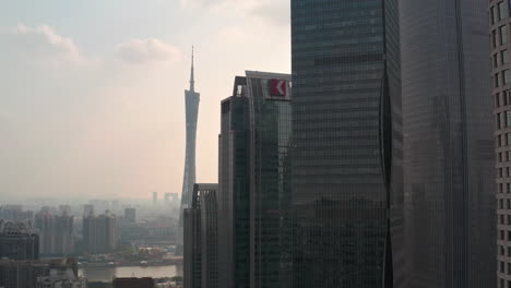 Epic-view-of-iconic-symbol-of-Guangzhou---Guangzhou-Tower-from-behind-downtown-office-buildings-at-colorful-golden-sunset