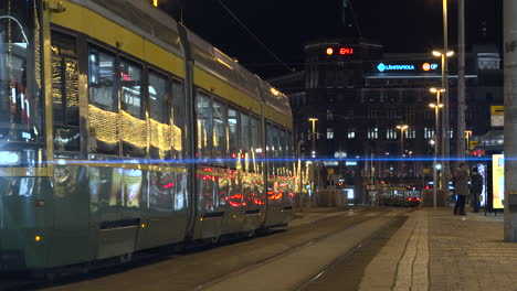 Time-lapse-of-downtown-with-Christmas-decorations,-people-and-tram
