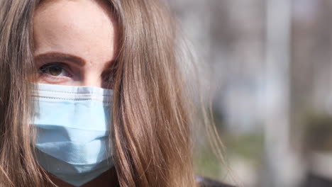 Close-Up-Portrait-of-a-Young-Woman-With-Face-Mask-Walking-and-Looking-at-Camera