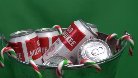 1-3-green-screen-looped-rotating-candy-canes-hanging-from-a-metalic-bucket-of-refreshing-sixer-of-an-old-milwaukee-canned-beer-iced-with-droplets-of-water-and-ready-to-be-quenched-for-the-festivities
