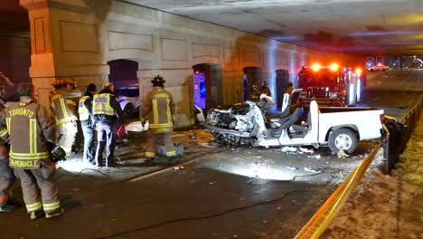 A-group-of-firemen-and-police-at-the-site-of-horrendous-crash-of-a-white-pickup-truck,-Mississauga,-Canada