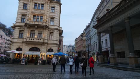 People-Walking-on-Paved-Public-Square-in-Downtown-Karlovy-Vary,-Czech-Republic