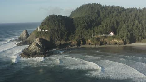 Wide-tracking-aerial-toward-Haceta-Head-lighthouse-in-Oregon