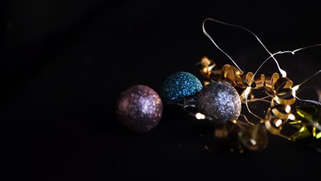 Christmas-decorations-and-lights-on-a-black-background-close-up-panning-shot