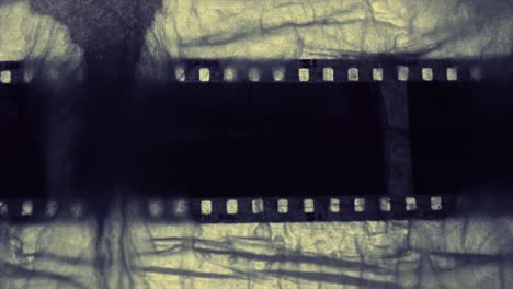 Black-ink-retreats-over-grungy-film-strip-overlay,-4k