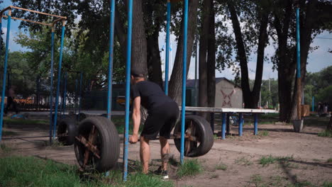 Young-man-working-out-in-public-outdoor-gym