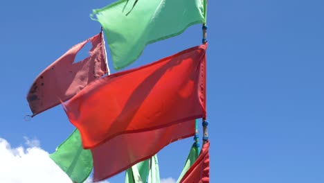 Red-and-green-flags-waving-in-the-wind