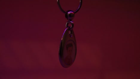 Close-Up-of-the-Hanging-Child's-Photo-in-Metal-Souvenir-Keychain
