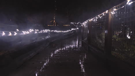 Wet-boardwalk-decorated-with-Christmas-lights