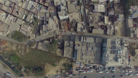 Bombay,-India,-Aerial-zoom-out-of-an-old-area,-showing-cars-moving-on-a-road,-Another-big-road-with-the-society