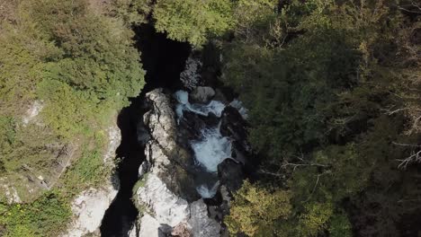 Top-view-of-the-mountain-river-with-a-small-waterfall