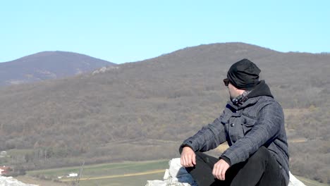 Hiker-boy-sitting-on-the-top-of-the-hill-in-Slovakia