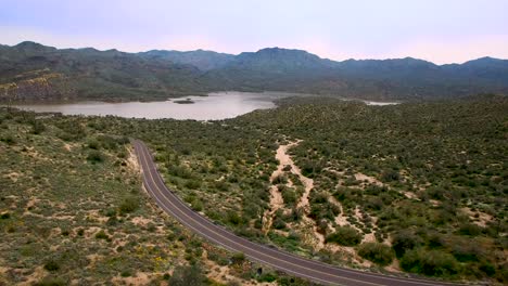 Aerial-push-in-on-Bartlett-Lake-Damn-road,-Tonto-National-Forest,-Scottsdale,-Arizona