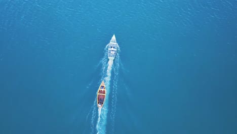 Aerial-Top-View-of-Two-Sailing-Boats-Passing-trough-the-Sea