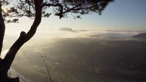 Saxon-Switzerland-morning-view-down-to-foggy-valley-and-Elbe-river