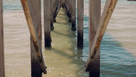 Underneath-an-old-wooden-jetty-looking-out-to-sea