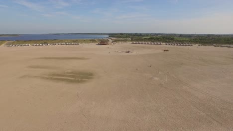 Aerial:-A-beach-club-on-a-large-beach-in-the-Netherlands