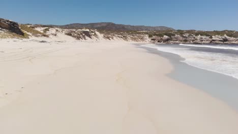 AERIAL:-Flying-close-over-beautiful-South-African-beach,-Western-Cape