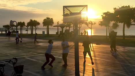 Teenagers-Playing-Basketball-on-Ocean-Side-court