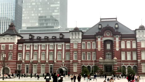 People-walking-around-the-old-building-of-tokyo-station,-Marunouchi-central-entrance-exit