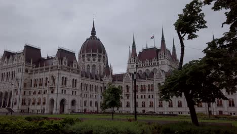 Hungarian-Parliament-Building-on-a-rainy-day,-filmed-from-tram-number-2-in-Budapest,-Hungary