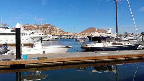 Steady-of-a-boat-and-sailboat-at-the-marina-of-Cabo-San-Lucas,-beautiful-morning-in-Baja
