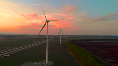 Drone-flying-towards-windmills-with-sky-in-background