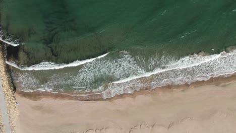 Beautiful-waves-hitting-the-shore---aerial-rotation-from-the-sky