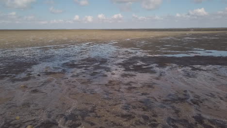 POV-walking-on-The-foreshore,-a-territory-at-low-tide,-accessible-for-a-few-hours-a-day:-covered-with-sand,-mud-or-rocks,-this-is-a-fragile-area