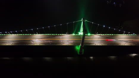 Aerial-Time-Lapse-of-Rush-Hour-Traffic-over-Suspension-Bridge-Illuminated-with-Neon-Lights---Hyper-Lapse