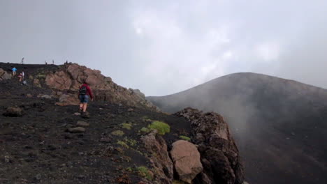 People-Making-Their-Way-Towards-Crater-of-Mount-Etna-With-A-Fumarole-Letting-Out-Steam
