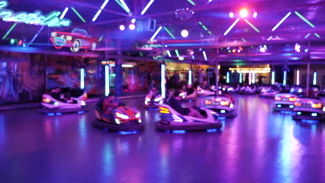 People-riding-bumper-car-during-illuminated-lightning-on-fairground,steady-shot