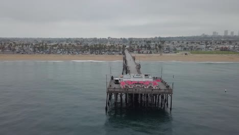 Approaching-California-Pier-End-from-Sea-with-Aerial-View-of-Oceanfront-Properties